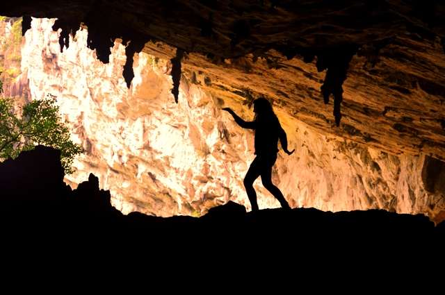 Tourists admire stalactites in Puong Cave